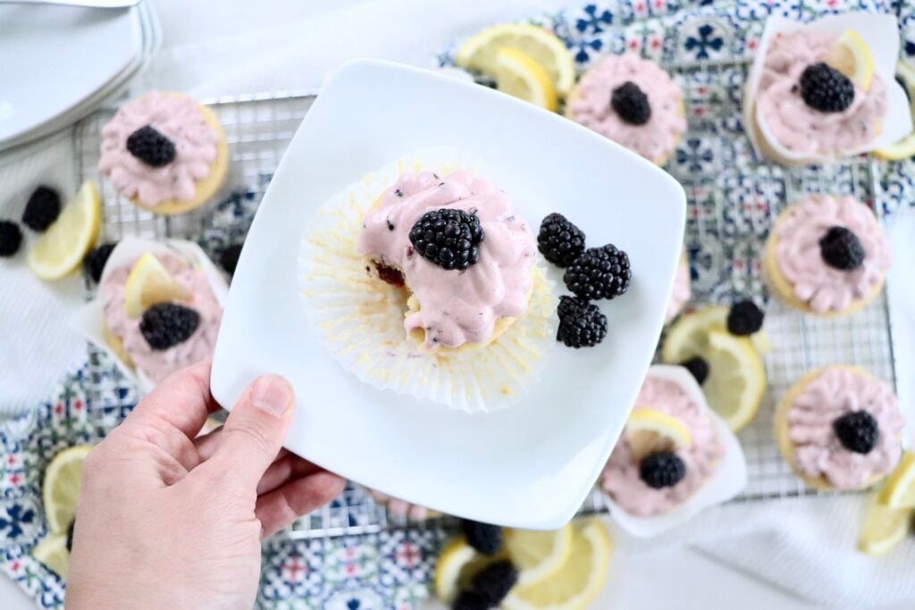Homemade lemon blackberry cupcakes with blackberry cream cheese frosting topped with fresh blackberries.