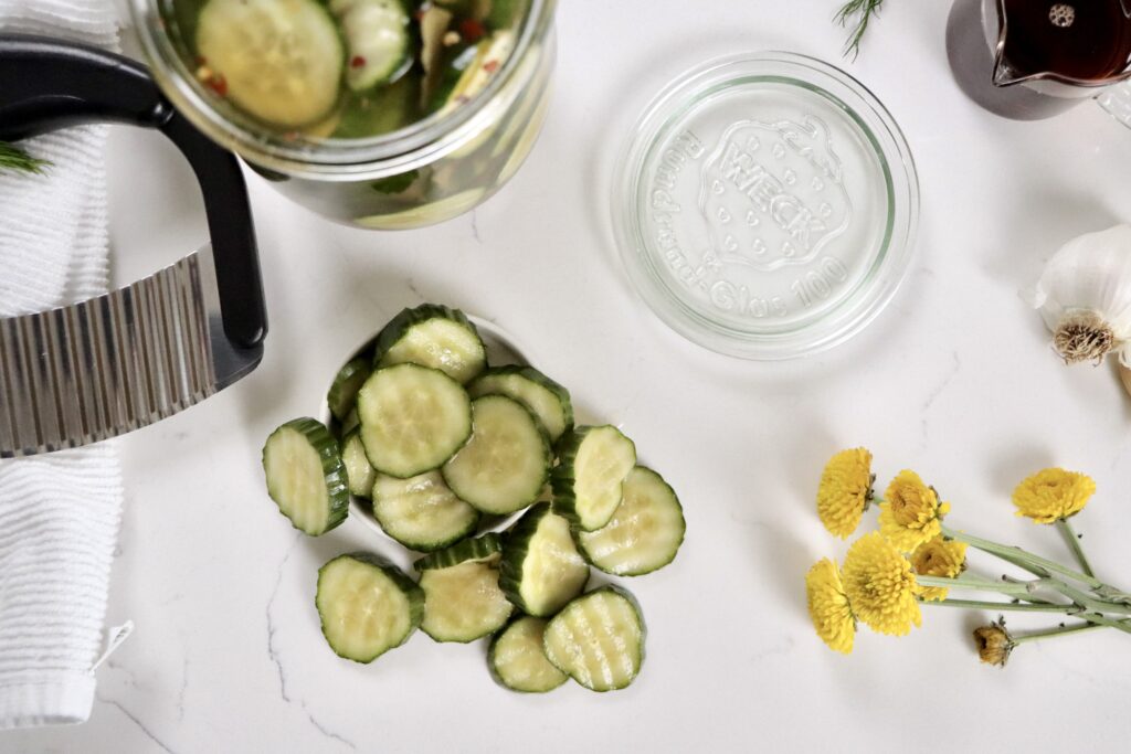 Fresh refrigerator pickles made with cucumbers, dill, garlic, and a sweet vinegar brine, ready to serve.