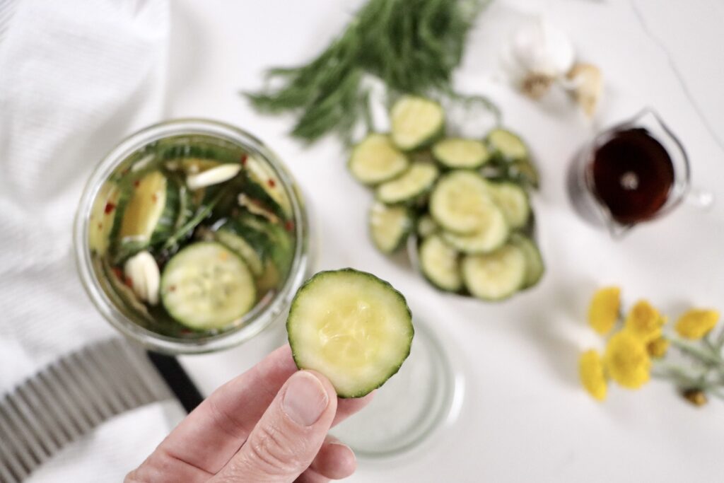 Close-up of crunchy sweet pickles in a mason jar, homemade and naturally sweetened with honey and maple syrup.