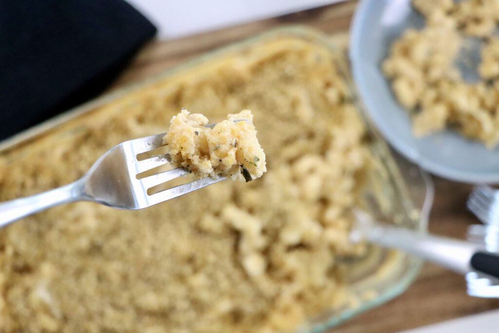Spoonful of homemade macaroni and cheese showing the rich and cheesy sauce.