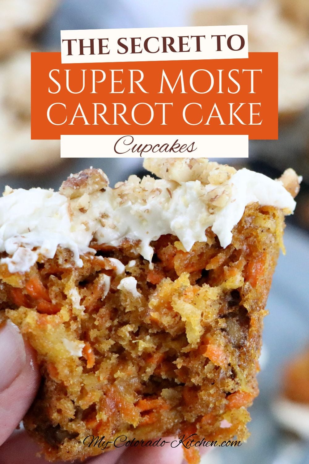 Carrot cake cupcake showing moist interior filled with carrots, pineapple, coconut, and walnuts
