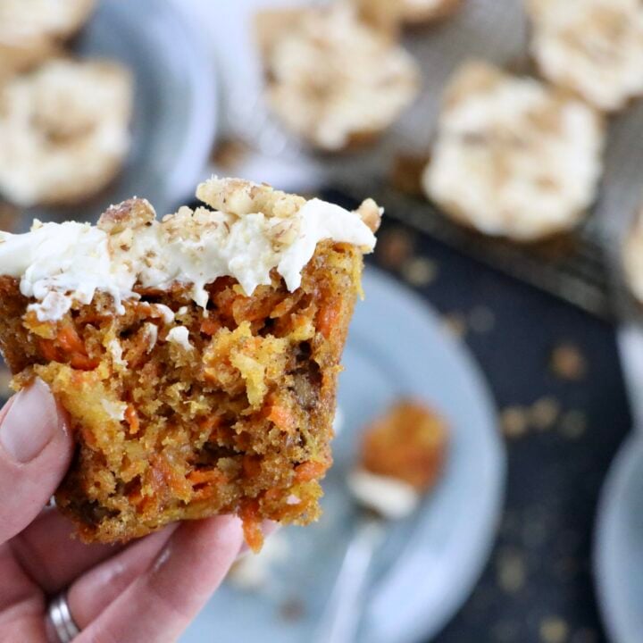 Carrot cake cupcake showing moist interior filled with carrots, pineapple, coconut, and walnuts