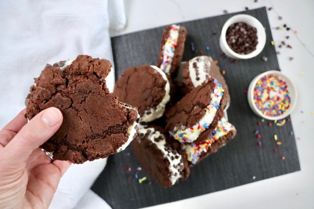 Close up of chocolate cookie ice cream sandwich made with soft chewy chocolate cookies and vanilla ice cream