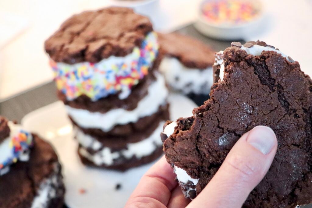 Soft chewy chocolate cookies sandwiching vanilla ice cream, homemade frozen dessert for summer