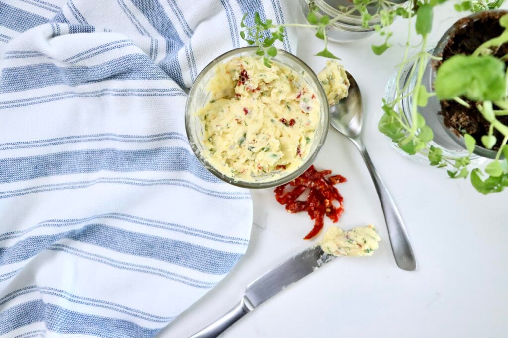 Homemade garlic herb compound butter ready to use for cooking scrambled eggs, spreading on bread, or melting over steak.