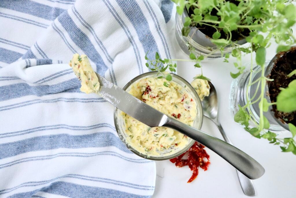 Homemade garlic herb compound butter ready to use for cooking scrambled eggs, spreading on bread, or melting over steak.