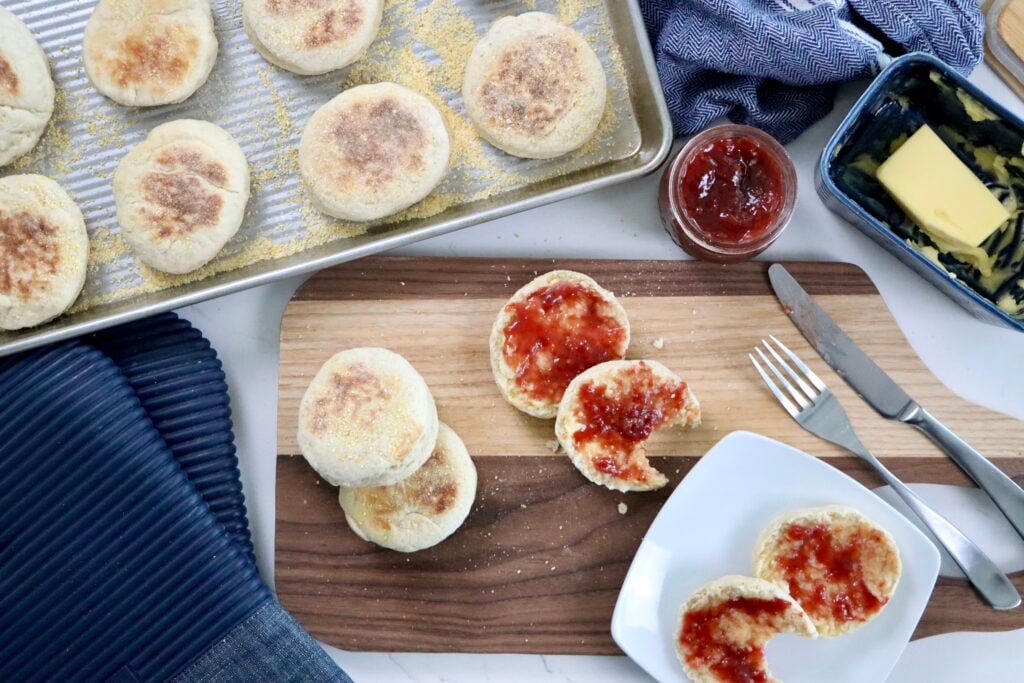 Soft and fluffy quick sourdough discard English muffins with a golden brown crust and visible cornmeal coating.