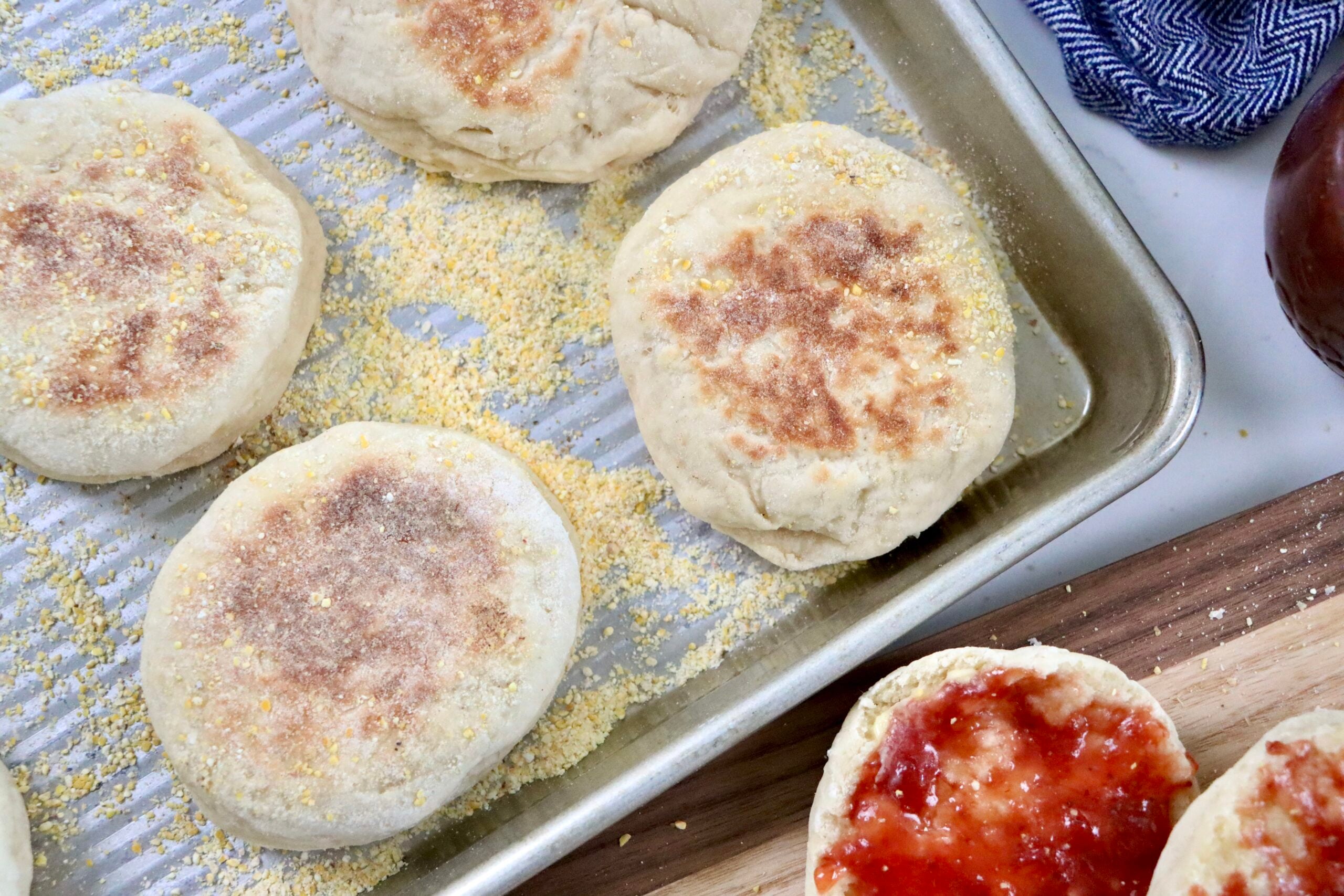 Cast iron cooked English muffins with sourdough discard showing evenly browned tops and rustic texture.