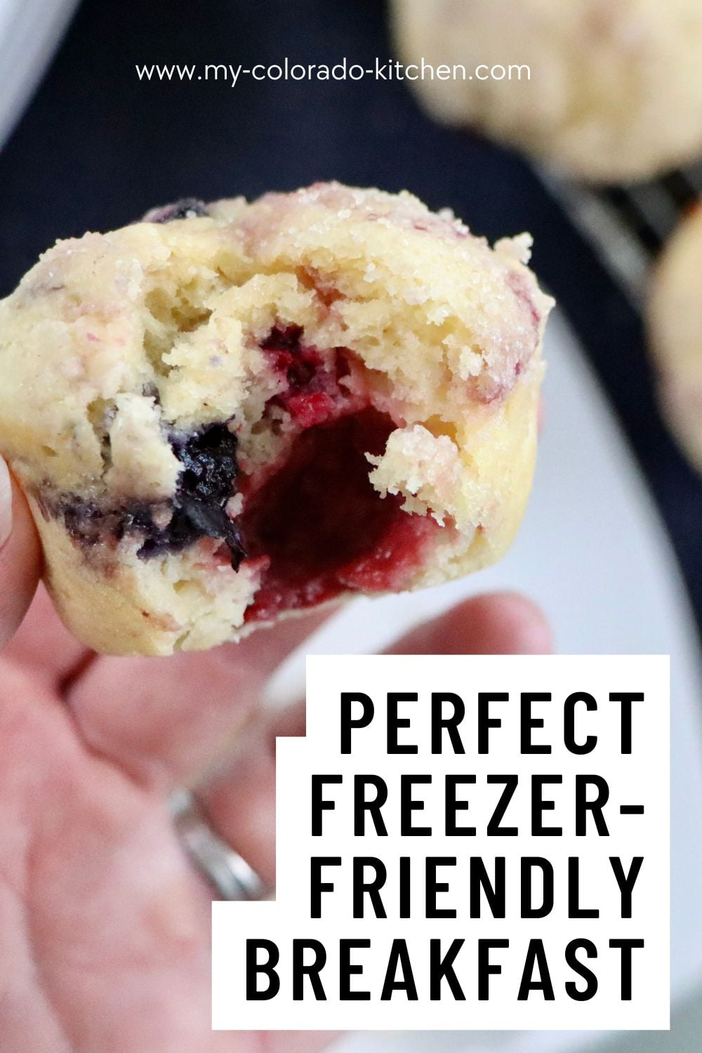 Bakery-style sourdough mixed berry muffins with tall muffin tops and mixed berries throughout.