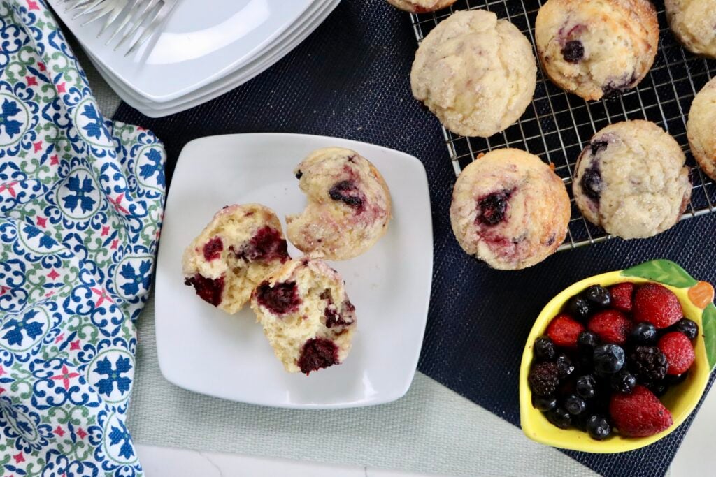 Soft and fluffy sourdough mixed berry muffins made with sourdough discard and frozen mixed berries.