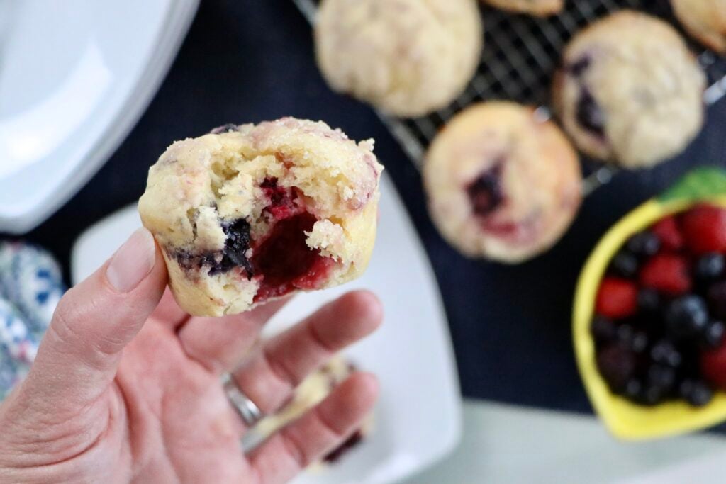 Homemade sourdough berry muffins bursting with blueberries, raspberries, and blackberries.