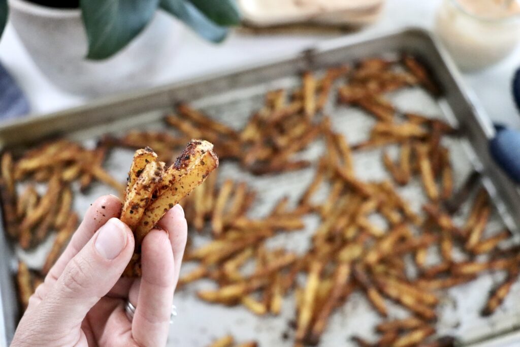 Close-up of homemade savory fries made with yellow potatoes, fresh from the oven