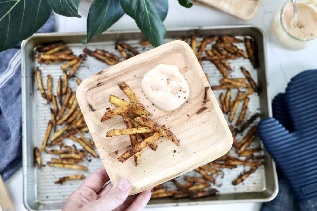 Close-up texture shot of crispy, golden savory fries with visible spice seasoning