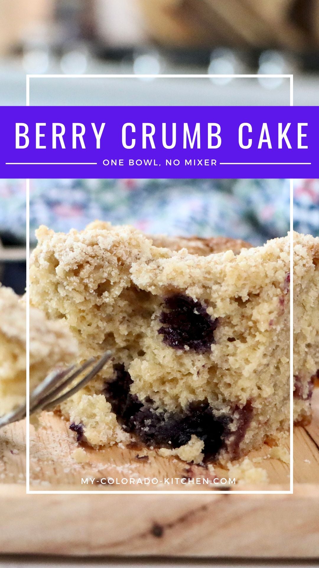 Close-up cross-section of berry crumb cake showing soft crumb, berries, and crumb topping layers