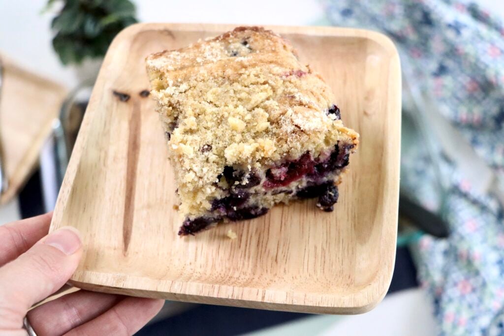 Close-up of buttery brown sugar crumb topping on a fresh-baked berry cake