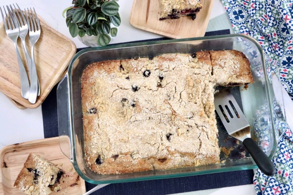 Overhead view of a berry crumb cake in a 9x13 pan with golden brown sugar crumb topping