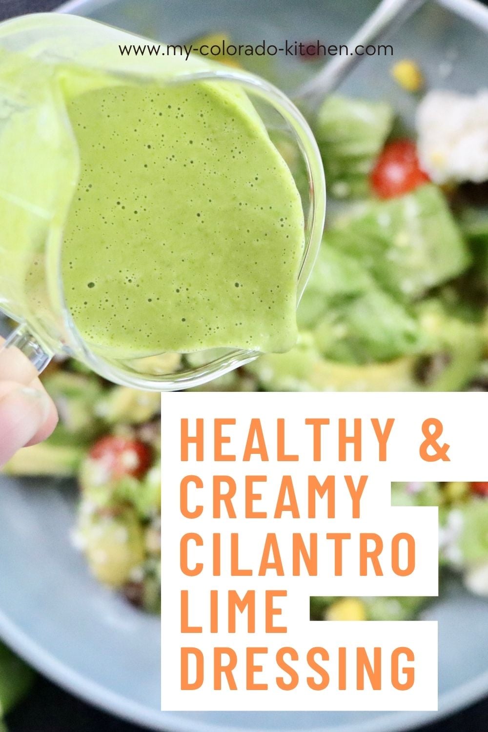 Close-up of homemade cilantro lime dressing being poured over a salad.