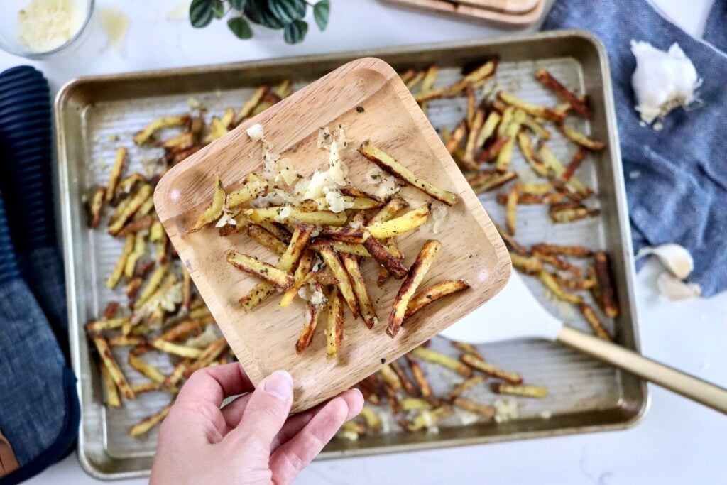 Close-up of oven-baked garlic parmesan fries with golden crispy edges
