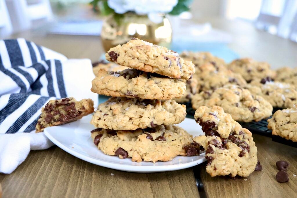Stack of soft oatmeal chocolate chip cookies on a white plate