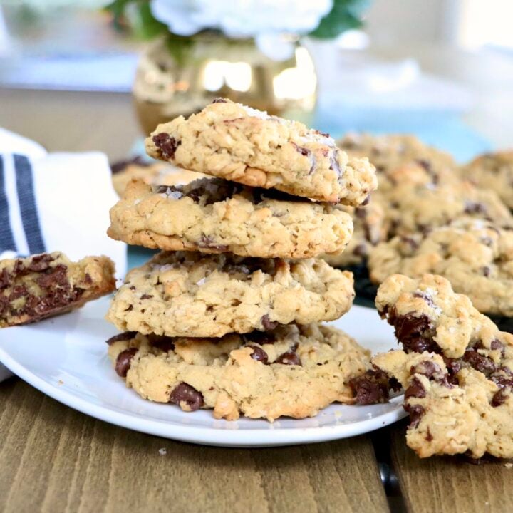 Stack of soft oatmeal chocolate chip cookies on a white plate