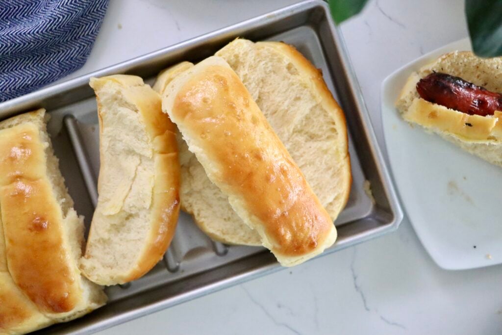Golden brown homemade hot dog buns that are soft, fluffy, and perfect for hot dogs or bratwurst.