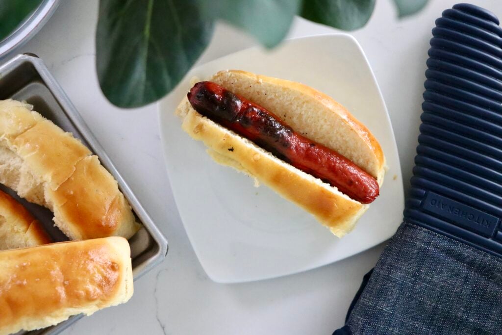 Fresh homemade hot dog buns made from scratch with simple ingredients and baked to a golden finish.