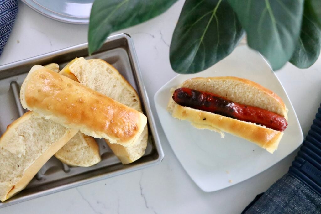 Homemade quick hot dog buns with a light, fluffy texture and golden tops.