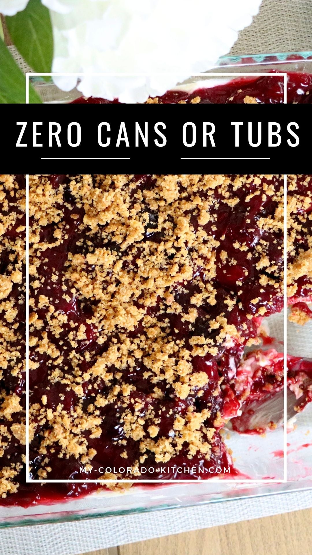 Close-up cross-section of cherry yum yum showing graham cracker crust, whipped cream cheese, and cherry filling layers