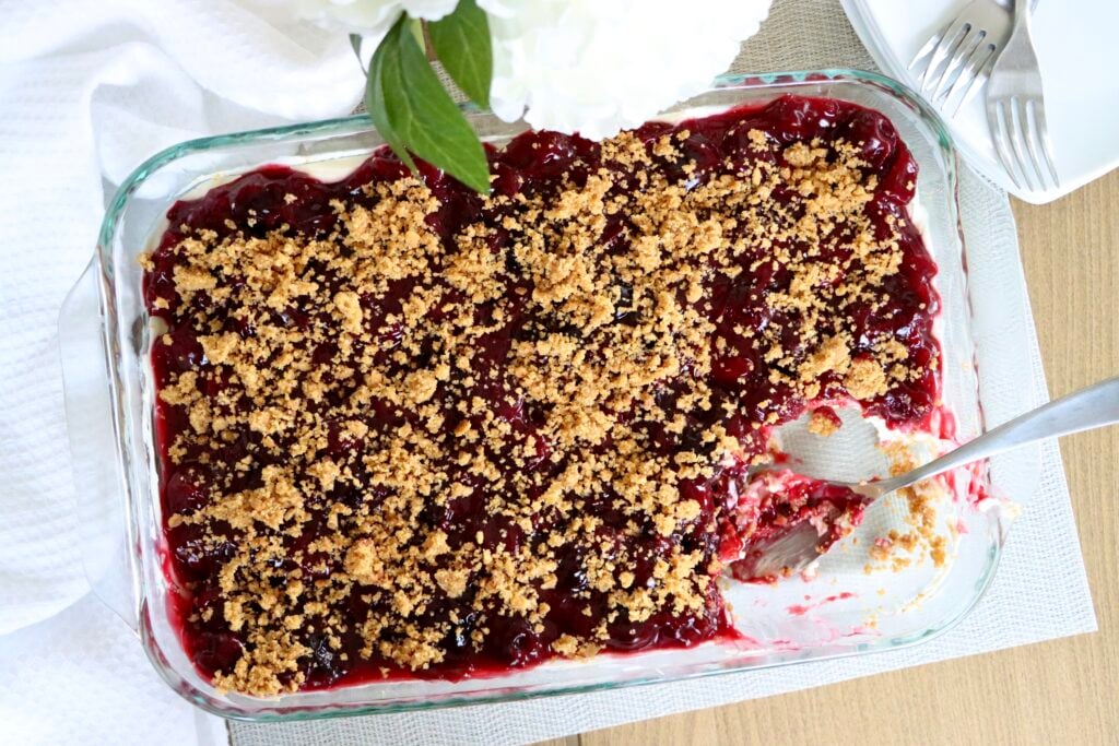 Cherry yum yum dessert with graham cracker crumb topping, ready to slice