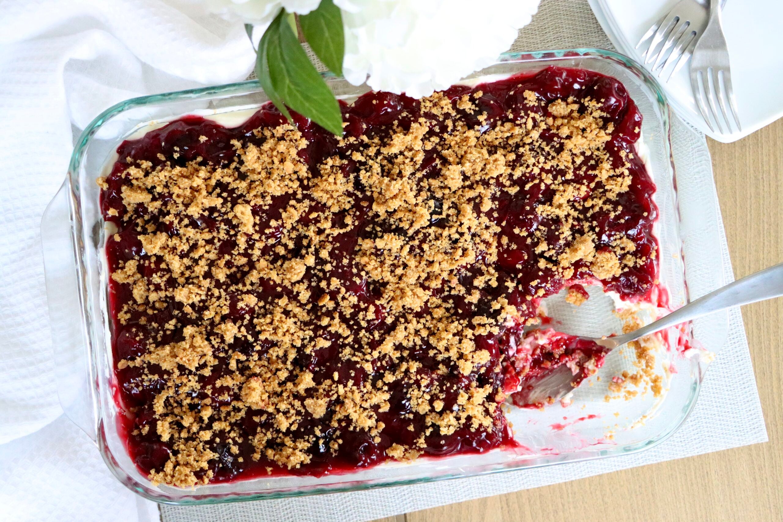 Cherry yum yum dessert with graham cracker crumb topping, ready to slice