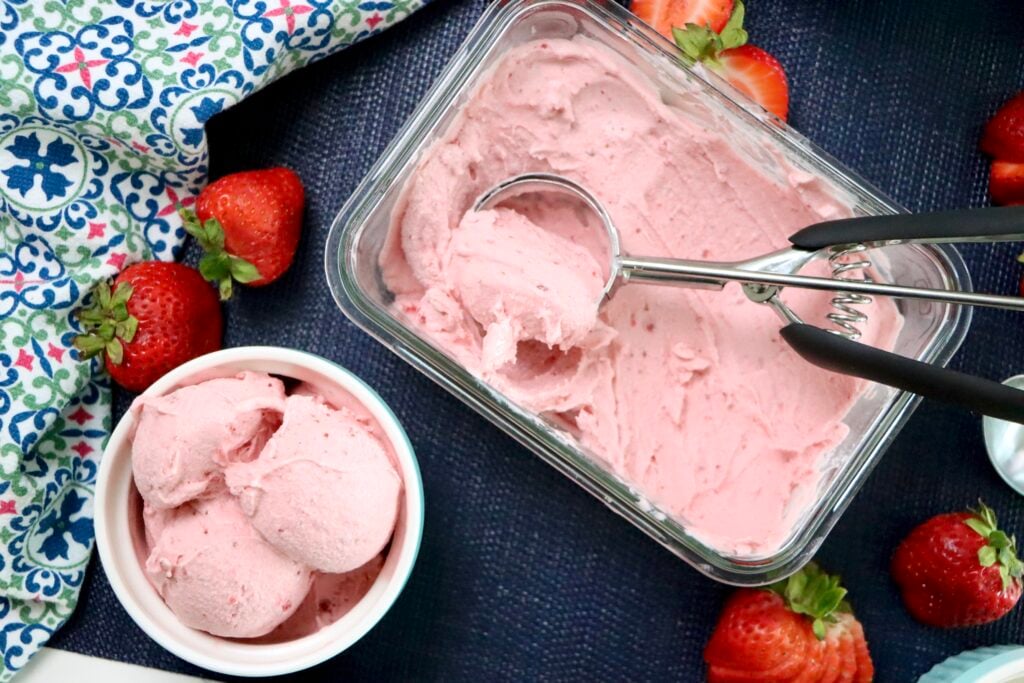 Close-up of creamy strawberry ice cream texture with visible berry pieces