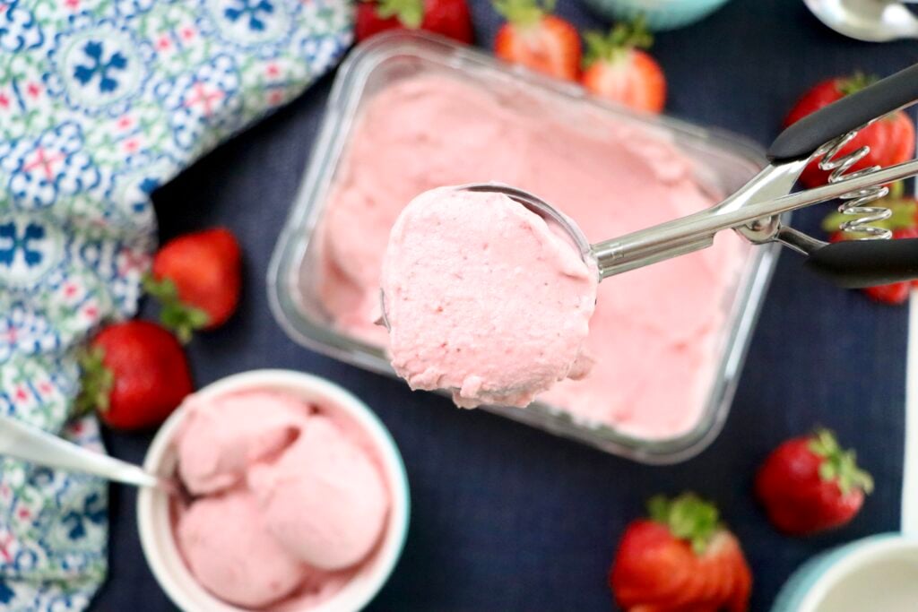 Scoop of strawberry ice cream in an ice cream scoop