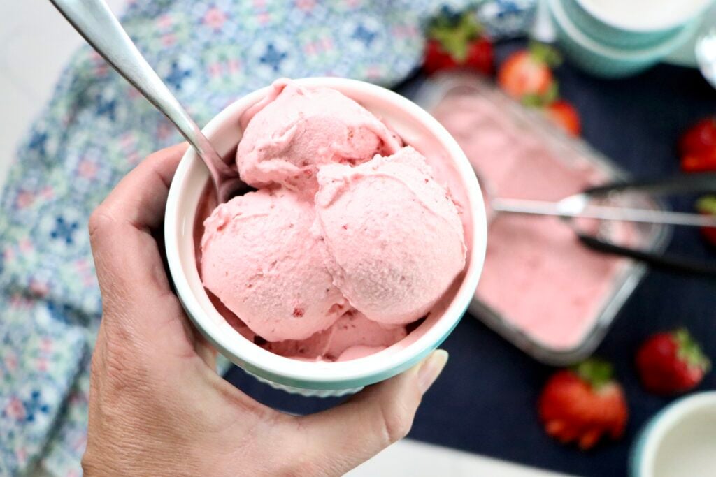 Bowl of creamy homemade strawberry ice cream with fresh strawberry chunks