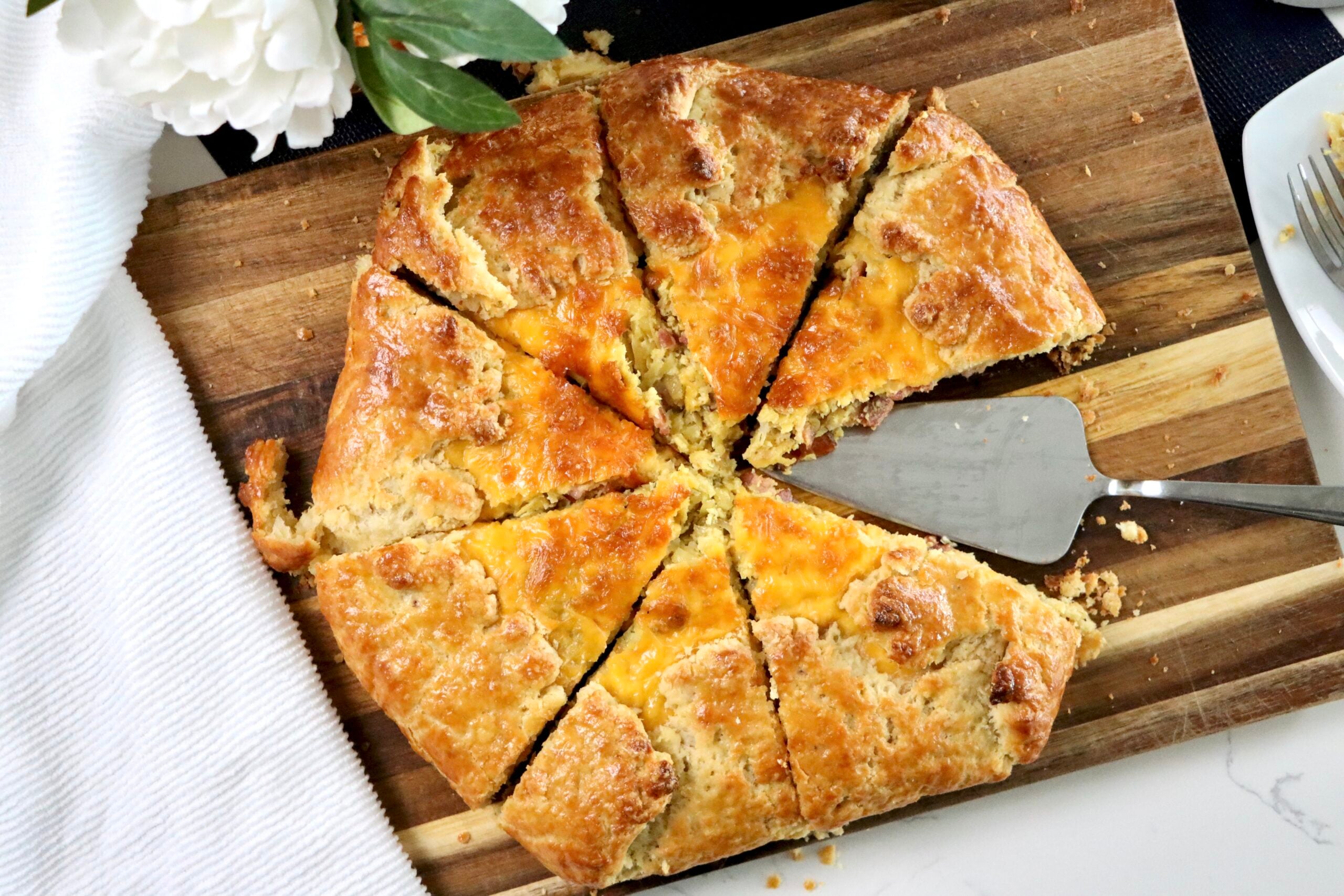 Loaded breakfast galette sliced open showing bacon, egg, and cheddar filling