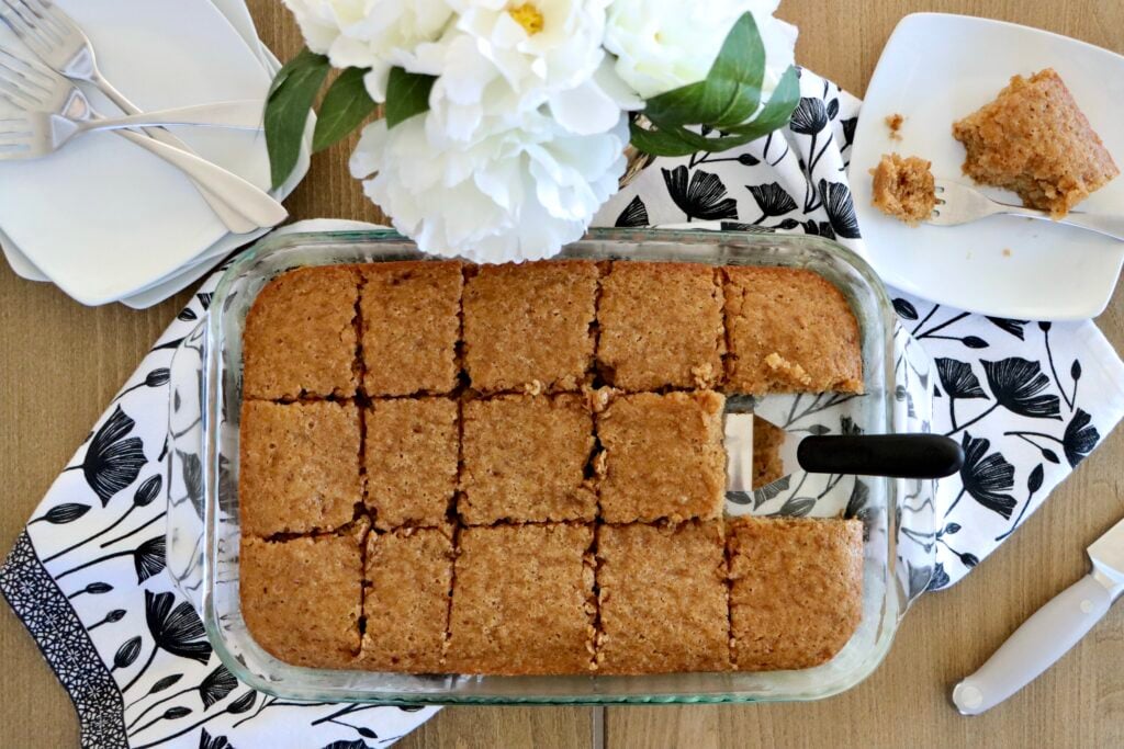 Slice of old-fashioned spice crazy cake on a white plate with a fork