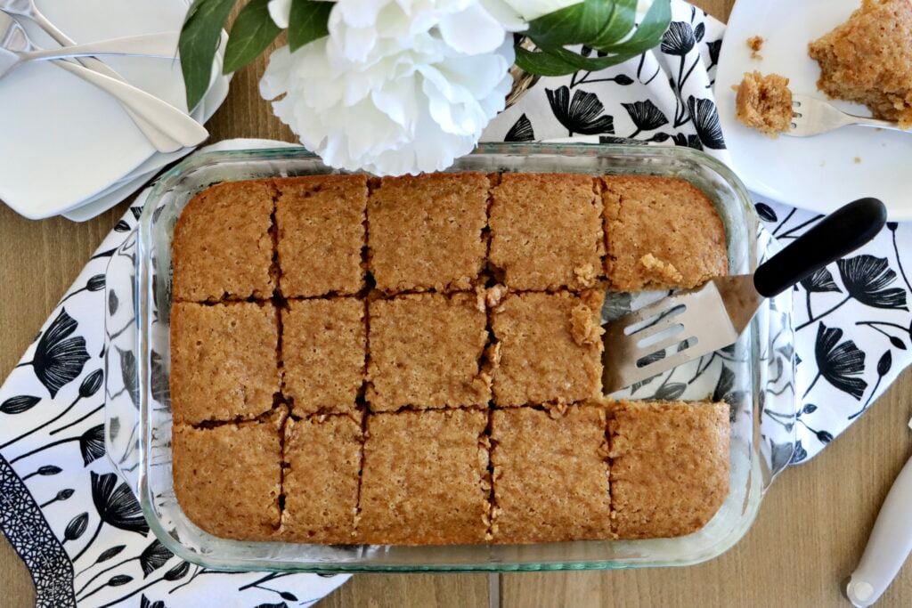 Overhead view of a 9x13 spice cake fresh out of the oven, cut into squares