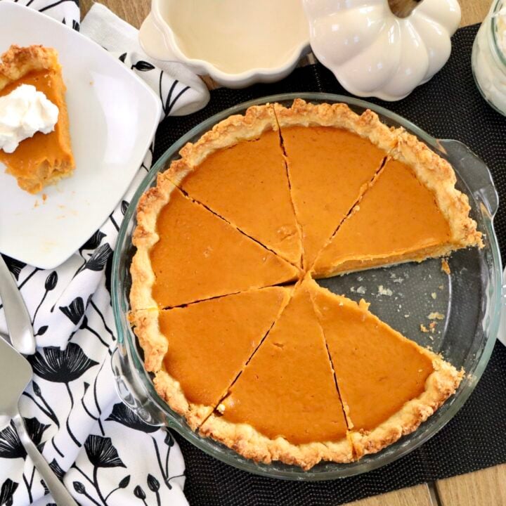 Overhead shot of pumpkin pie with one slice removed, showing silky filling